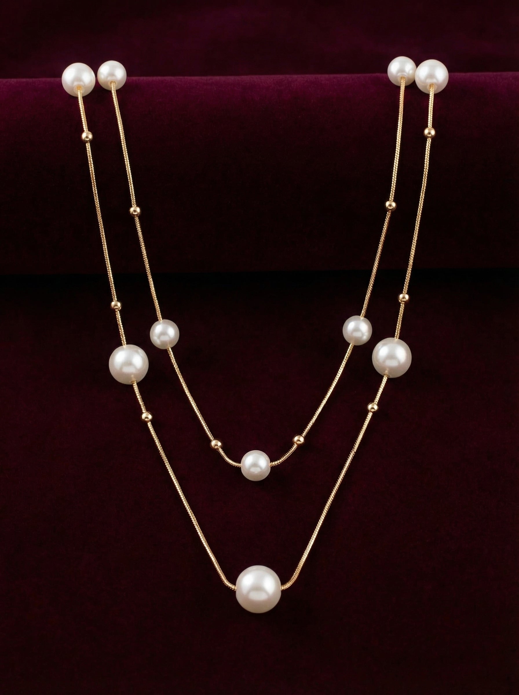 Two-layer pearl necklace on a dark purple background