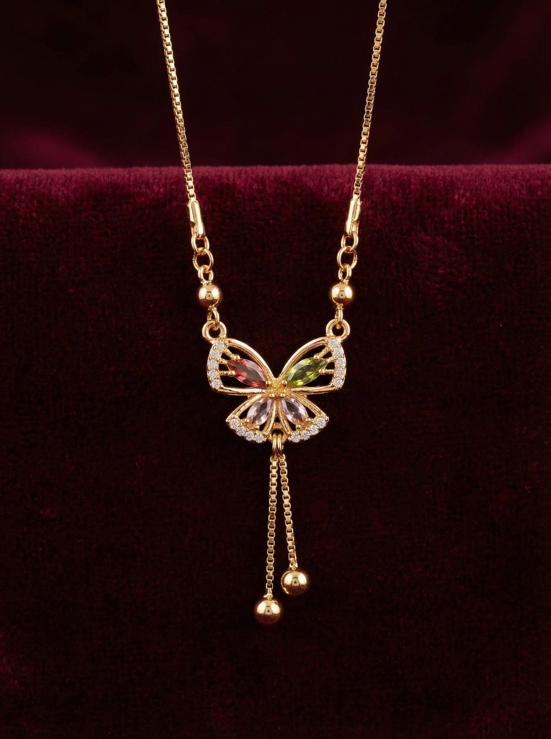 Butterfly-shaped pendant necklace on a dark background