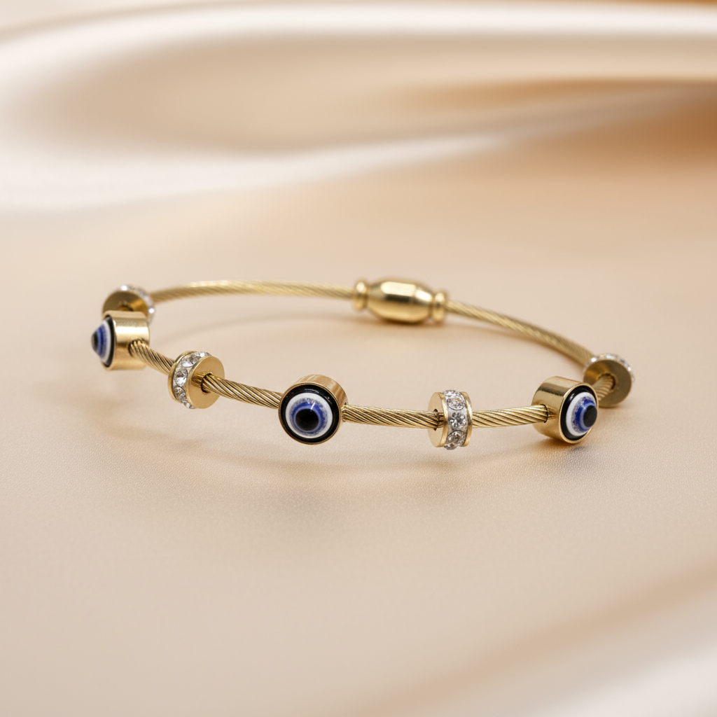Enhanced studio image of the gold-plated Evil Eye protection bracelet, showing full product shape and luster on a smooth, neutral background.